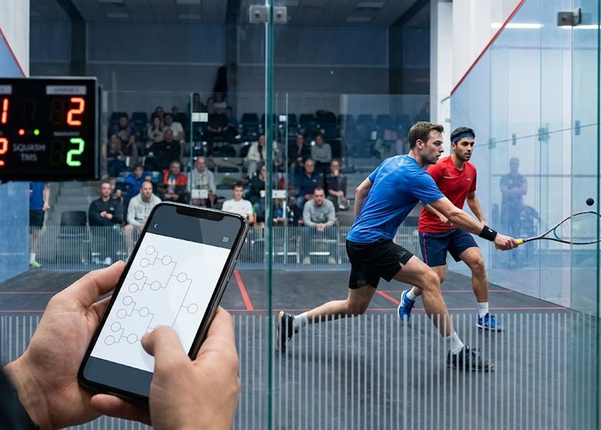 Squash player on glass court